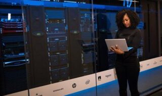 Software Engineer Standing Beside Server Racks