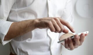 person holding white Android smartphone in white shirt